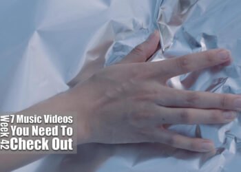 Still from the music video of Taiko Super Kicks for the track "火遊び (Hiasobi)". A hand is placed on aluminium foil.
