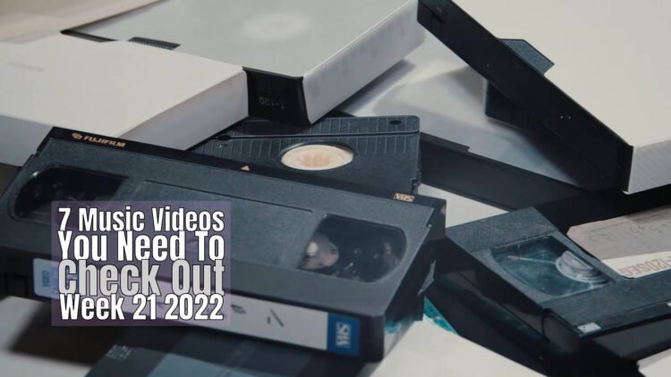 Still from AMANOJAKU's music video for "フィクション (Fiction)". A shot of a lot of video tapes.