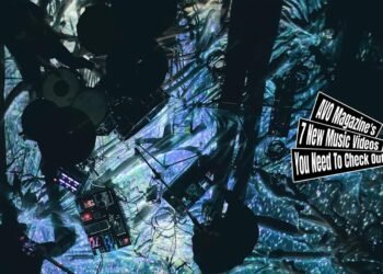 A still from Sore Demo Sekai Ga Tsudukunara's music video for "流星群 (Meteor Shower)". The four members of the band perform on a floor with draped cloths. A number of lights are shining on the floor, giving it an illuminating spacy effect. The musicians themselves are not in the light, so they have become silhouettes. It was filmed from above.