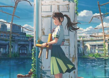 Suzume holds a small wooden chair and stands in front of a door.