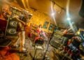 An action shot of the three members of Green Milk from the Planet Orange in the middle of a performance.