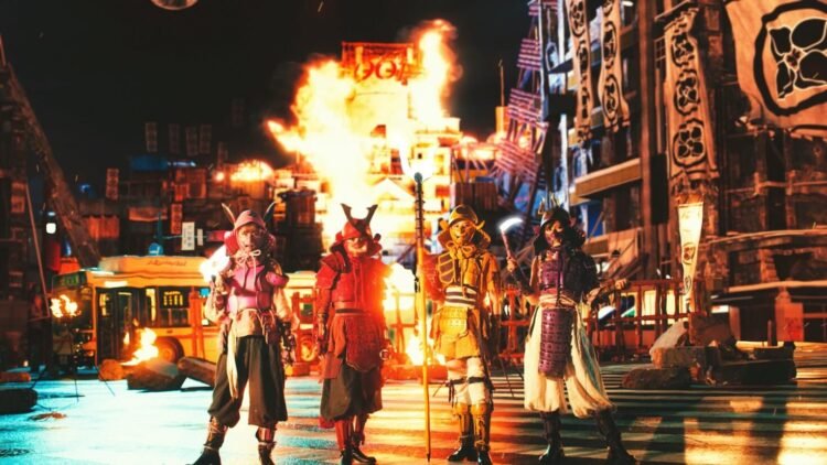 Still from Momoiro Clover Z's music video for "MONONOFU NIPPON". The four group members are standing on a dystopian version of Shibuya Scramble Crossing, dressed in armour reminiscent of samurai.