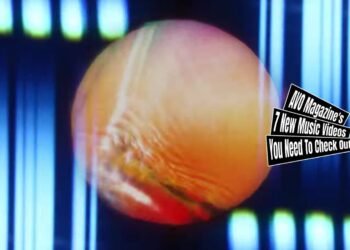 Still from HAPPY's music video for "Sundowner". The still consists of splashes of colours, a round circle representing the sun and effects that make the still abstract looking.