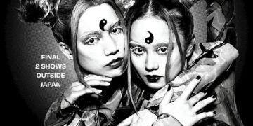 Monochrome photo of RiRi and LuLa of FEMM embracing each other in an artistic way while looking at the camera.