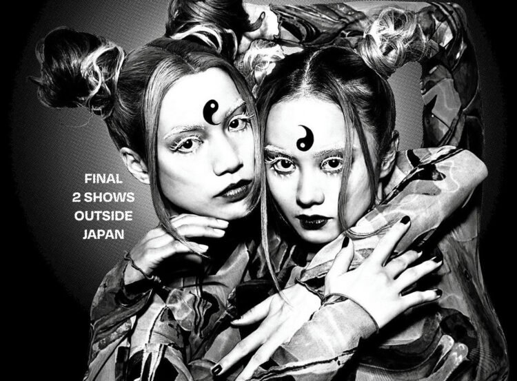 Monochrome photo of RiRi and LuLa of FEMM embracing each other in an artistic way while looking at the camera.