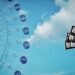 Still from Jikou's music video for the song "マイナスヨンド (Minus 4℃)". The still contains a part of a Ferris wheel and the daylight sky with a big cloud.