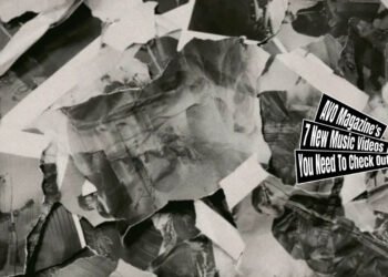 Still from the music video for "誰かの声 (Dare Ka No Koe)" by Switchblade. The still shows an accumulation of printed A4s showing the band members performing the song in a room. Some papers are crumpled or torn.