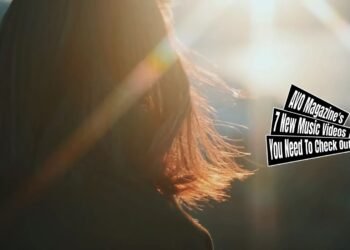 Still of Cavalier's music video for "Luna". A girl with half lang dark brown hair, a model named Aika Kaneko, walks around the city while the sun is shining bright. Her hair in the sun is focused in this still.
