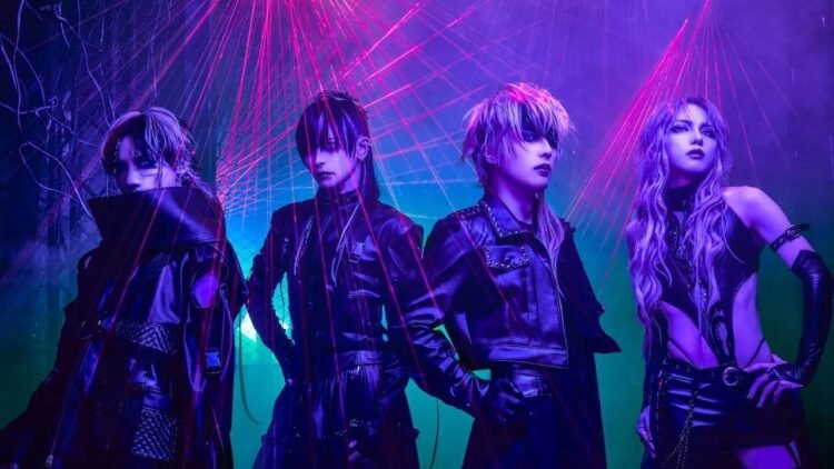 The photo depicts the four band members of JILUKA standing in a row surrounded by lights (in various colours and forms) shining from different angles, creating a mysterious and lively atmosphere. The lighting in the picture is also often used concerts or dance parties. All band members are dressed in black clothing what seems to be leather or leather-like.