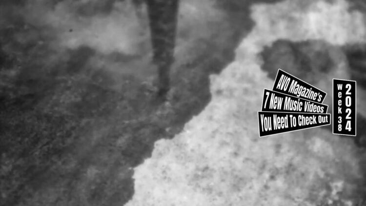 A still of the music video "輪 (Zoetrope)" by ゆうさり (Yuusari) - directed by Shiro Ose. The still is monochrome and shows the ground with puddles of water and a reflection of what appears to be a tower or a long pole. Director Shiro Ose (@shiro_ose on Twitter/X) shared in a tweet that the music video is filmed with a toy camera.