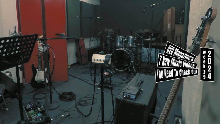 Still from the music video for "浮力 (Furyoku)" by the band 毛布にくるまって (Moufu ni Kurumatte). The still shows a rehearsal space equipped with various music instruments (such as a guitars, pedal board, amps, drumkit, and microphones) for a band.