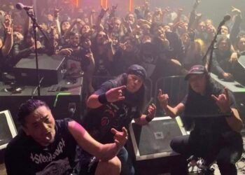 The Japanese band Abigail posing in front of an audience after a live show.