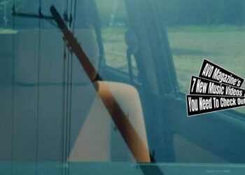 Still from the music video by しろつめ備忘録 (Shirotsume Biboroku) for the song "アクセルペダル (Accelerator pedal)", directed, filmed and edited by Moriaki Suzuki and Kojiro Yamaguchi. The still shows a car's windscreen, reflecting an electricity pole and cables while you can also see the front seat.
