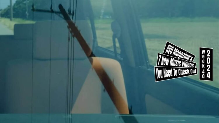 Still from the music video by しろつめ備忘録 (Shirotsume Biboroku) for the song "アクセルペダル (Accelerator pedal)", directed, filmed and edited by Moriaki Suzuki and Kojiro Yamaguchi. The still shows a car's windscreen, reflecting an electricity pole and cables while you can also see the front seat.