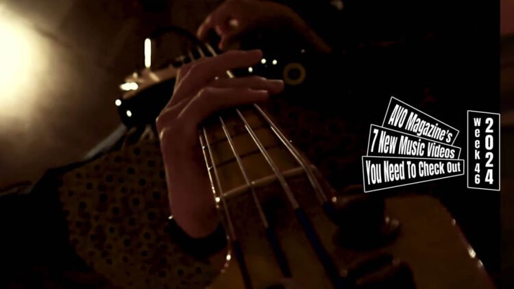 Still from "影郎 (Kagerou)" by ウスバカゲロウ (USUBAKAGELO). With the camera clipped onto the bass guitar, you can see the point of view from the headstock with the focus on the snares and the hands of the player. Videographer and editor: fumiya ozawa