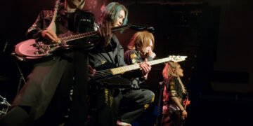 Four members of NIGHTMARE at the front of the stage, standing closely together during the performance in London. Photo by JJ Grant/wonderlens