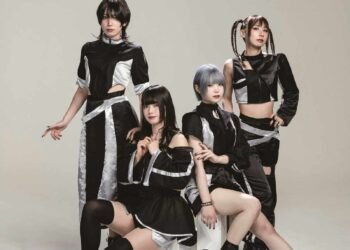 The photo features the four members of Broken By The Scream posing against a light background, two of the members are sitting on white blocks, while the other two are standing behind them. They are wearing coordinating black and silver costumes and each having a unique hairstyle.