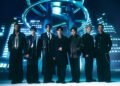 Photo of the seven members of PSYCHIC FEVER from EXILE TRIBE standing next to each other in a futuristic setting. They are dressed in dark clothing, inspired by suits, but with different elements showing their personalities, from leather jackets to extra accessories.