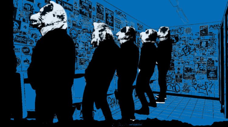 A photo of the five band members of MAN WITH A MISSION standing in the men's restroom “marking new territory,” a reference to their upcoming world tour. The photo has been edited to give it a cartoon-like appearance with blue background, black silliouettes and the members' wolf heads in a halftone-ish filter. Taken from the tour flyer promoting the European summer tour. © Sony Music Labels Inc. / Century Media Records