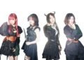 The photo shows the steampunk metal band FATE GEAR, dressed in dark gothic and steampunk inspired fashion standing next to eachother against a white background.