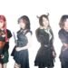 The photo shows the steampunk metal band FATE GEAR, dressed in dark gothic and steampunk inspired fashion standing next to eachother against a white background.