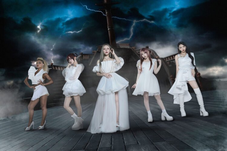 The photo features the five women of LOVEBITES posing together while standing on a ship, with dark clouds with lightning in the background. They are uniformly dressed in white/off-white with gold elements outfits, each incorporating their personal style. LOVEBITES © Napalm Records