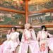 Seth, Kouki and Tsukasa of Sakura Zensen dressed in traditional kimono with hakama, with pink and red hues and floral patterns. They are seated side by side with Japanese (wooden) artworks in the background. © Sakura Zensen