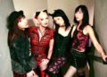 The photo features the four members of MIKABOMB (Also written as MIKA BOMB), all dressed in an alternative fashion style, wearing punk-inspired attire. They are standing close together on a flight of stairs.