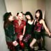 The photo features the four members of MIKABOMB (Also written as MIKA BOMB), all dressed in an alternative fashion style, wearing punk-inspired attire. They are standing close together on a flight of stairs.